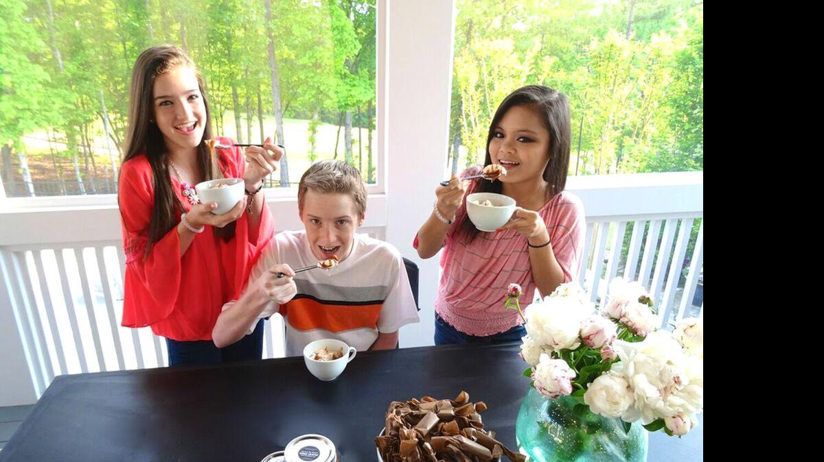 
Mari Hudson and her friends Ryan and Sarah Williams enjoy Stirred by Hand confections. The Fort Mill-based company is also invested in supporting organizations that promote and facilitate adoption.
