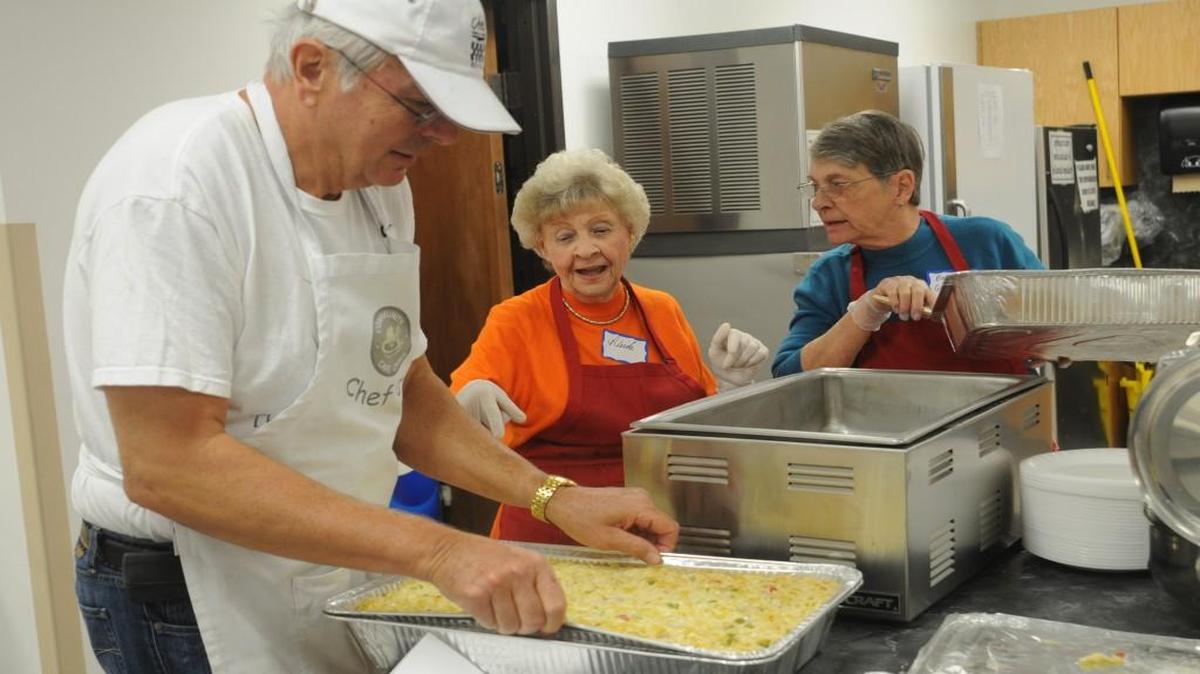 Don Murfin, Neida Gunn and Betsy Goodwin serve meals at a Community Cafe in Lake Wylie.