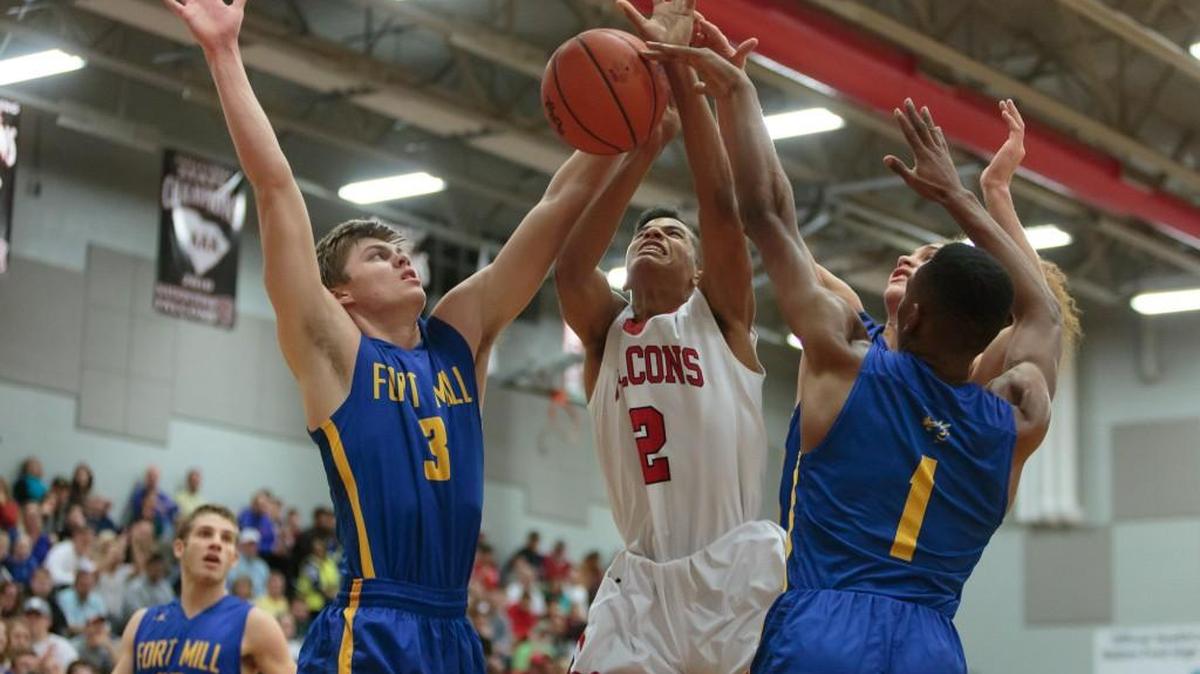 Fort Mill defenders triple-team Nation Ford's Eric Moulds. The Jackets won their second consecutive region title.