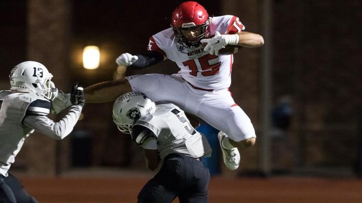 Nation Ford’s Hank Tuipulotu tries to go over York’s Ketrael Lytle in 2016 4A Division II playoff game. Tuipulotu considered an offer from the S.C. Gamecocks but opted for BYU.