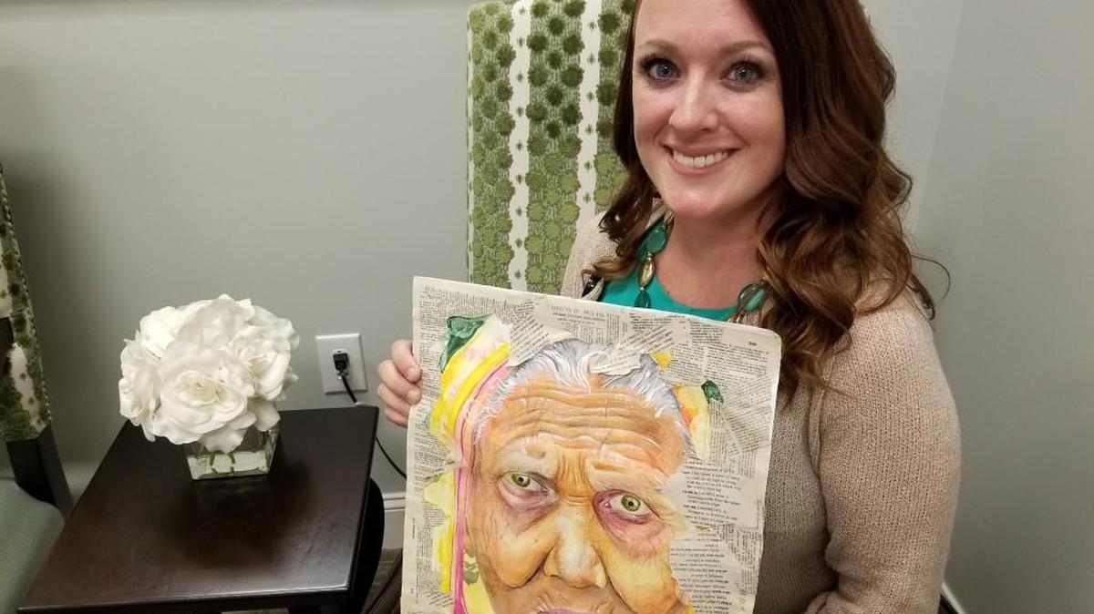 Ms. South Carolina Strawberry Festival Janine Bents holds a piece of artwork donated to Wellmore of Tega Cay's art auction to benefit the Alzheimer's Association. As a titleholder and Wellmore employee, Bents has been involved in raising awareness and funds for the cause that is close to heart.