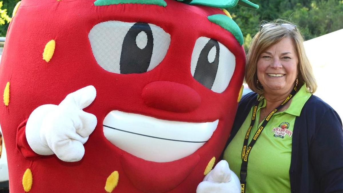 Fort Mill Mayor Guynn Savage takes a selfie with Berry B. Good, the S.C. Strawberry Festival mascot.