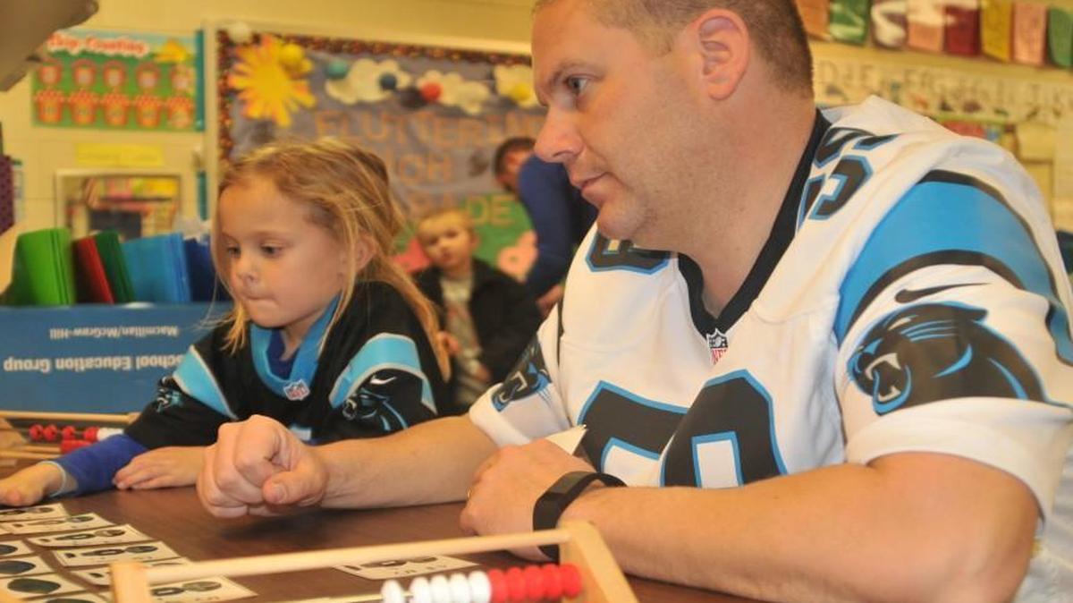 Joe Barsanti spends time with his daughters at Fort Mill Elementary School in Friday.