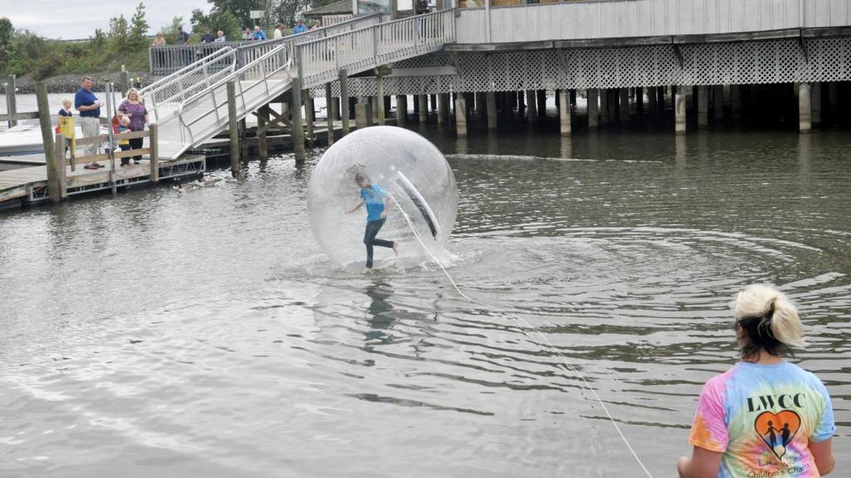 
Kaitlyn McBee, 12, of Lake Wylie takes a turn in the bubble ball on the water outside T-Bones on the Lake during Lake Wylie Children’s Charity Benefit Concert Oct. 4. 
