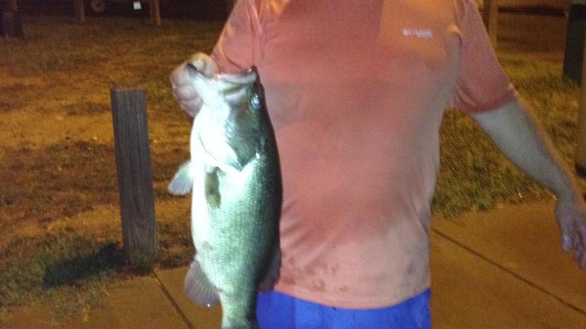 
Brian Huskins hold up the 6.37-pound bass he and son Cole reeled in during the July 30 Thursday Night Tournament Trail on Lake Wylie. 
