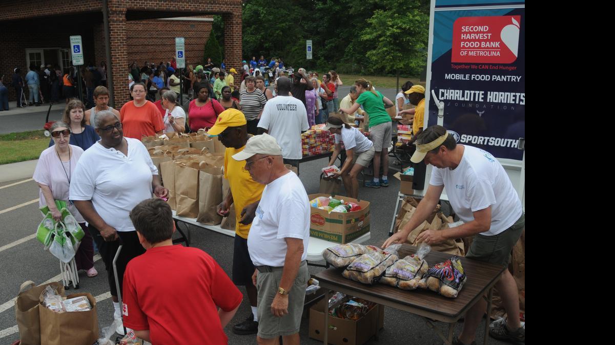 
Volunteers distribute food Friday at Unity Presbyterian Church in Fort Mill, through the Second Harvest Food Bank of Metrolina program that will bring more events to Clover this year.
