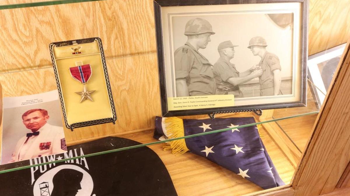 A display at Tega Cay's Glennon Center honors the service of local veterans such as Henry Eldridge, who is shown in the photo receiving the Silver Star.