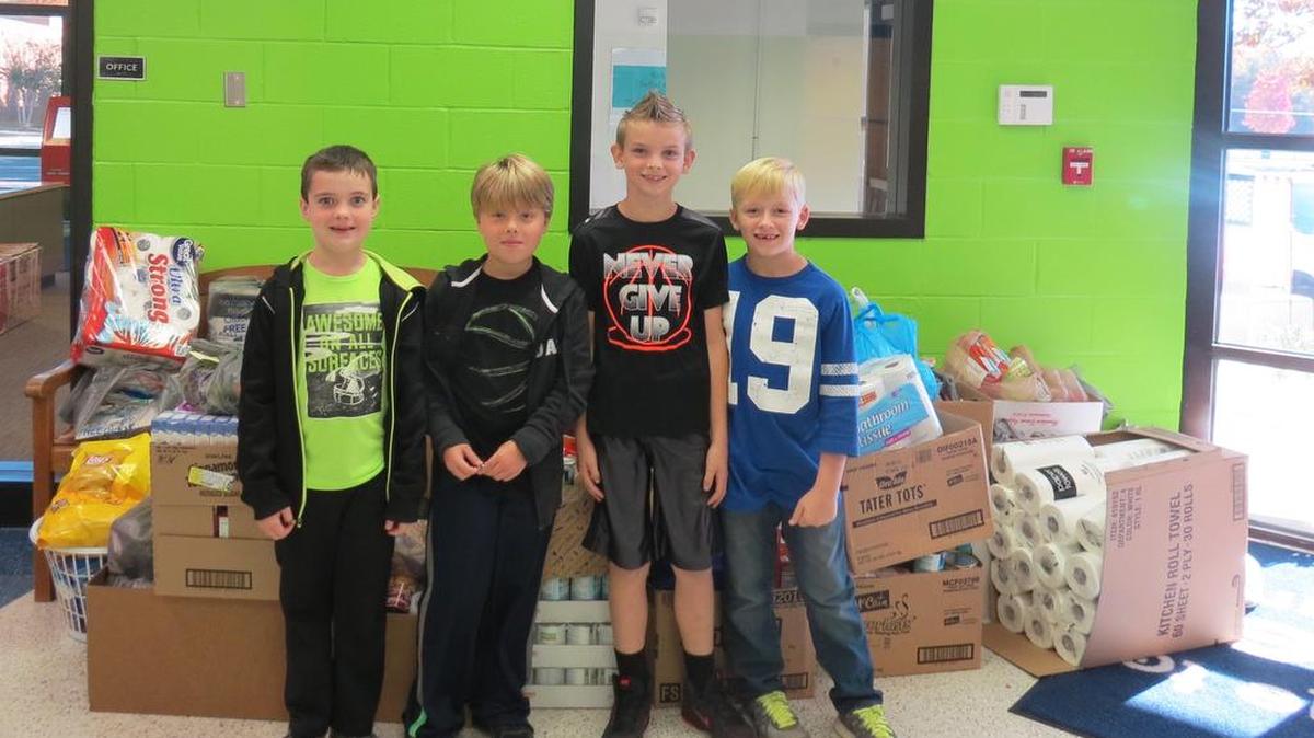 Terry Jackson, third-grade teacher at Bethel Elementary, helped students organize a schoolwide food drive to benefit Clover Area Assistance Center. Students, families and staff collected 965 pounds of food. Participating students from left are Ryan Jones, Aedan Hewlett, Dawson Parton and Carson Politsch.