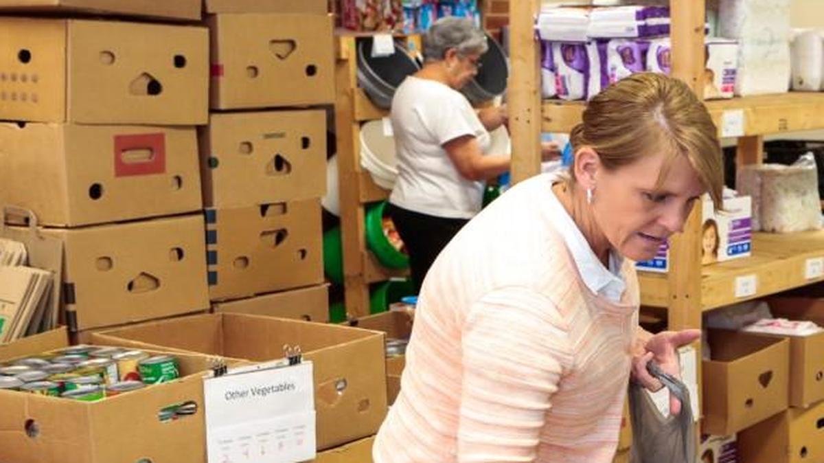 Volunteer Jana Arbon fills an order as the Fort Mill Care Center gets ready for the holidays at a new location.
