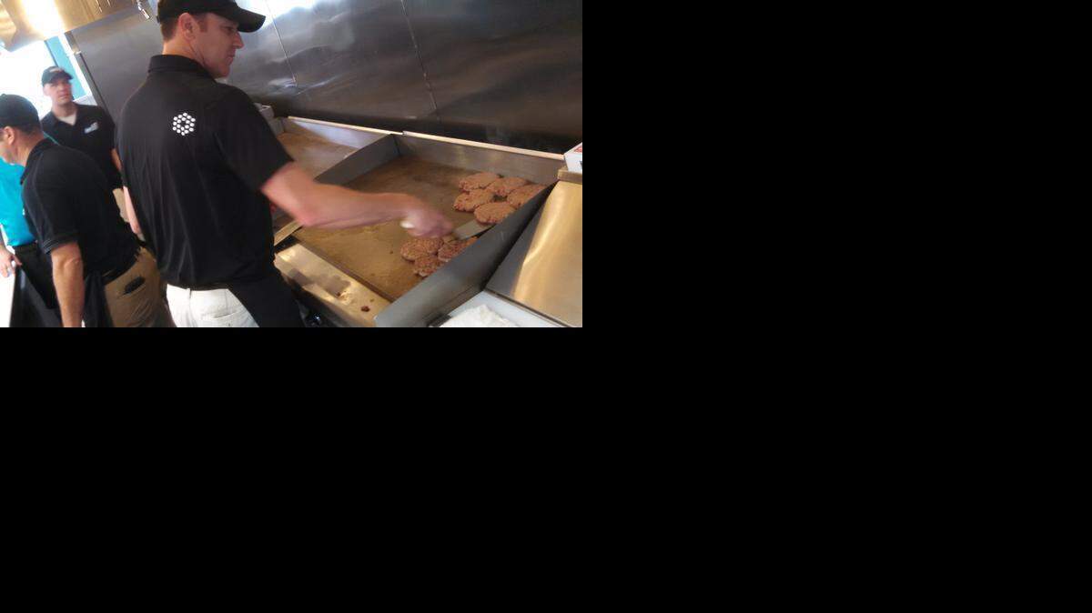 
Chris LaCoe cooks up the first burgers Monday at Hwy 55 Burgers, Shakes & Fries in Fort Mill.
