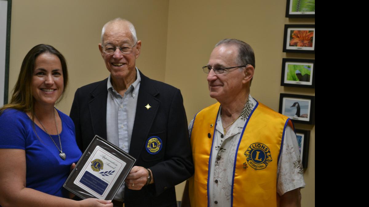 
River Hills/Lake Wylie Lions Club past president Lee Rowley, center, and current president Len Fleet present an appreciation award to Lake Wylie Pilot editor Kitty Muccigrosso.
