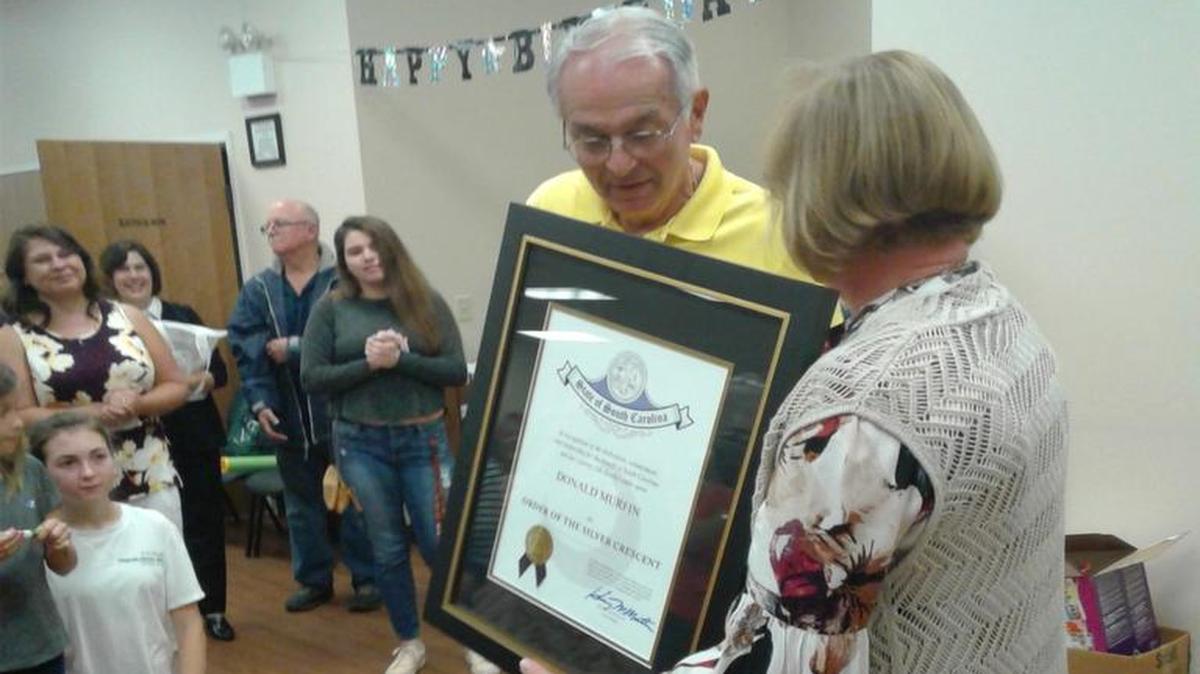 Don Murfin, left, received the Order of the Silver Crescent, the highest award for community service in South Carolina.
