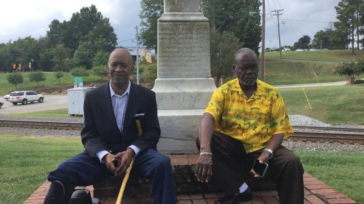 Cousins Charles White-Kiser, left, and Daniel Watts, of Fort Mill, at a monument that honors “faithful slaves” of the Confederacy in Fort Mill including their great-grandfather Handy White that is unique in South Carolina and one of just three in America. The family wants the monument to stay up as controversy swirls over Confederate monuments.