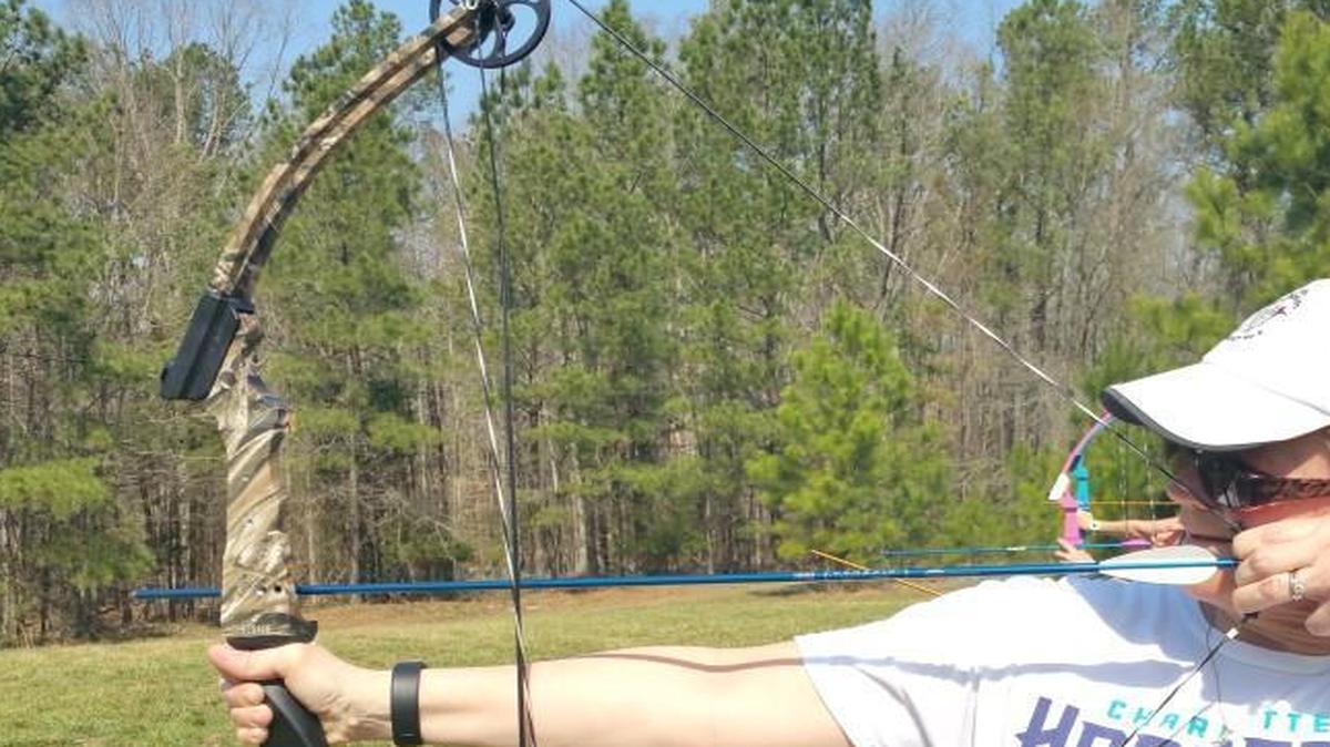 Fort Mill resident Kathy Ernst participates in archery at the first annual Wild Women conference at the Anne Springs Close Greenway. Ernst said she came seeking a respite from stress and to focus on herself for a change.