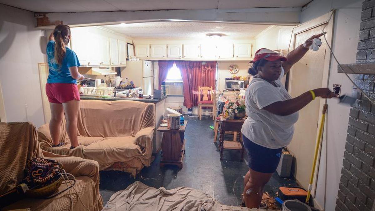
Jordyn Holden, left, of Florence, and Brittney Culbreath of Columbia, paint the living room of a home near Van Wyck during last week’s Salkehatchie Camps. 
