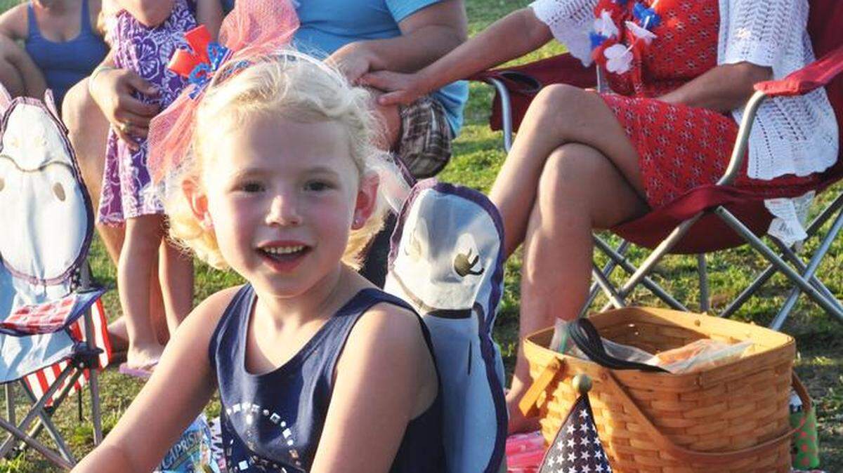 Ellodie Thomas, front, and sister Bailee, father Jason, and mother Linley from Steele Creek picnic July 4 at the Buster Boyd Access Area in Lake Wylie while they wait for the sun to go down and fireworks show to start.