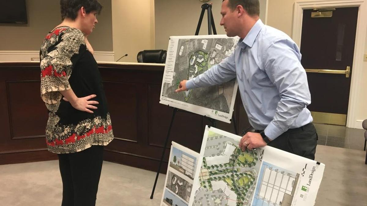 LandDesign principal landscape architect Shawn Tooley, right, explains Red Ventures' master plan to Black Horse Run resident Toni Carney at Lancaster County Board of Zoning Appeals' public hearing.