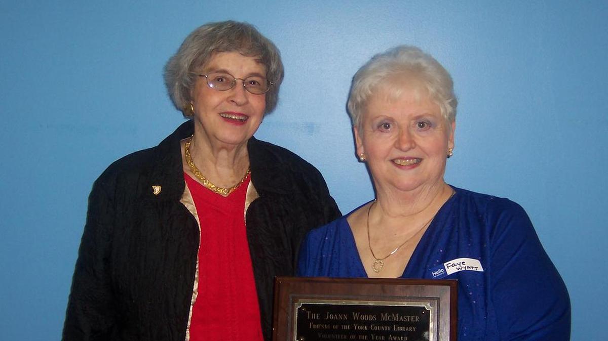 Joann McMaster, right, presents the York County Library volunteer award named in her honor to Faye Wyatt of Rock Hill.