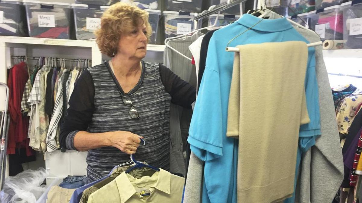 
Paneen Froneberger sorts clothes for the Community Clothing Closet held in the church’s all-purpose room. 
