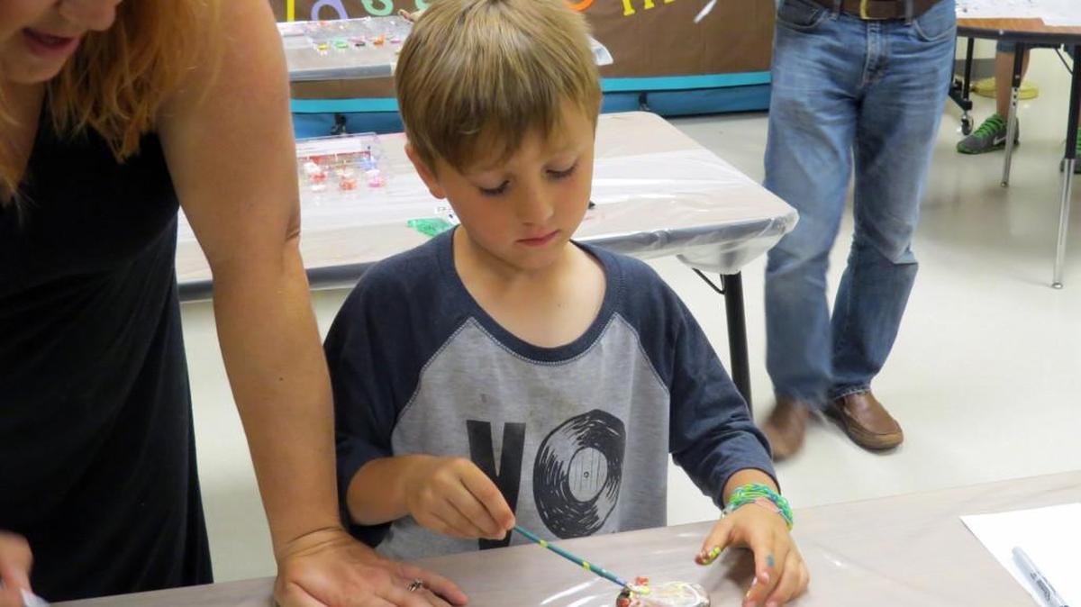 Nikolai Caton, 6, paints rocks for Pleasant Knoll's outdoor classroom during the school's second annual Family Science Night last spring. The school district’s student population continues to grow and is nearing 14,000 among all Fort Mill Schools.