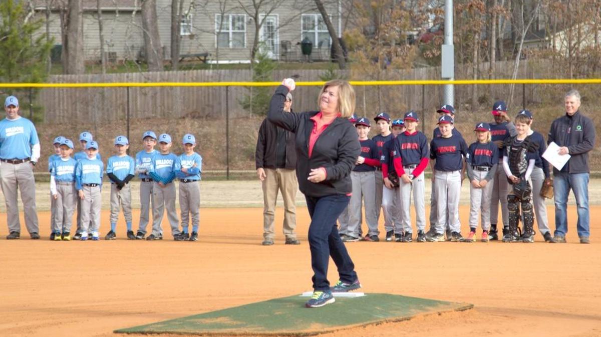 In this file photo, Fort Mill Mayor Guynn Savage throws out the first pitch to start rec baseball season in Fort Mill at Doby Bridge Park. The town just announced the park will expand by about half its size.