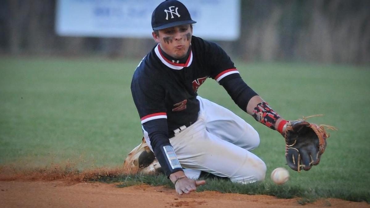 Nation Ford second baseman Carter McCrain makes a sliding stop of a ball headed for right field during the secondinning Friday against Northwestern. McCrain was able to make the throw to first in time to record the out.