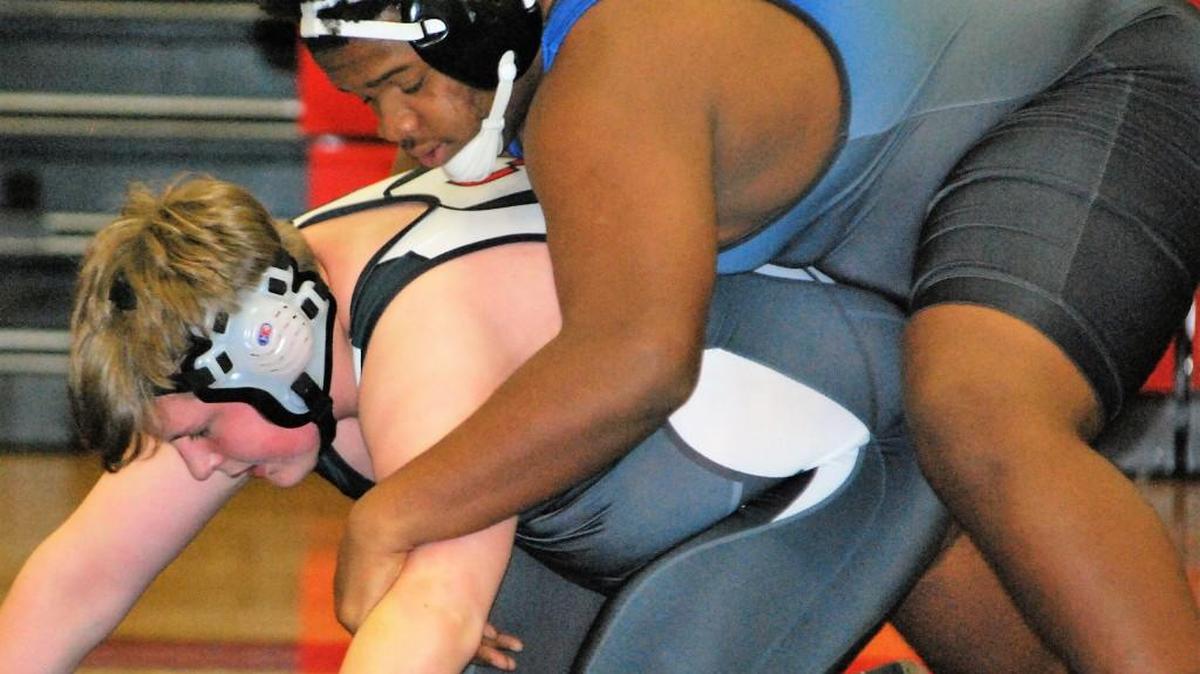 Fort Mill’s Jaquan Johnson, top, and Nation Ford’s Sean Grennan wrestle in the heavyweight bout during the teams’ dual. Fort Mill won to complete an undefeated region schedule.