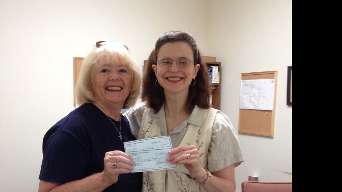 
PATH Executive Director Cheri Curtain, right, accepts a $7,000 donation from River Hills/Lake Wylie Lions Club Past President and PATH volunteer Dona Van Leer.
