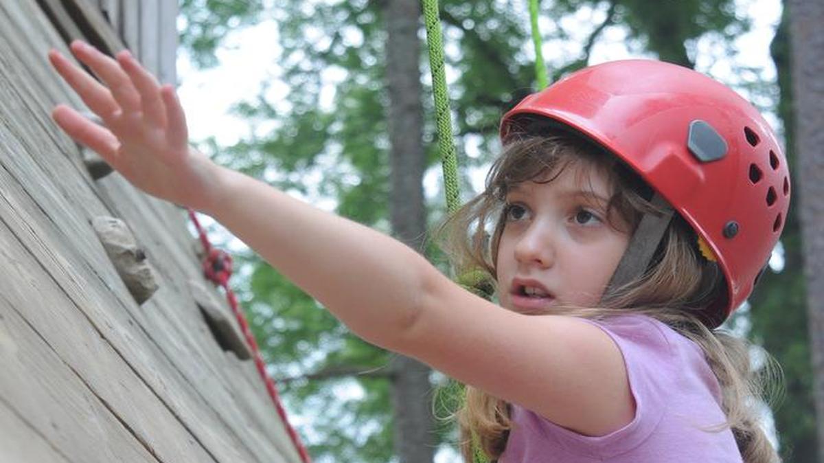 
Gracie Camp, 7, climbs a wall at Camp Thunderbird.
