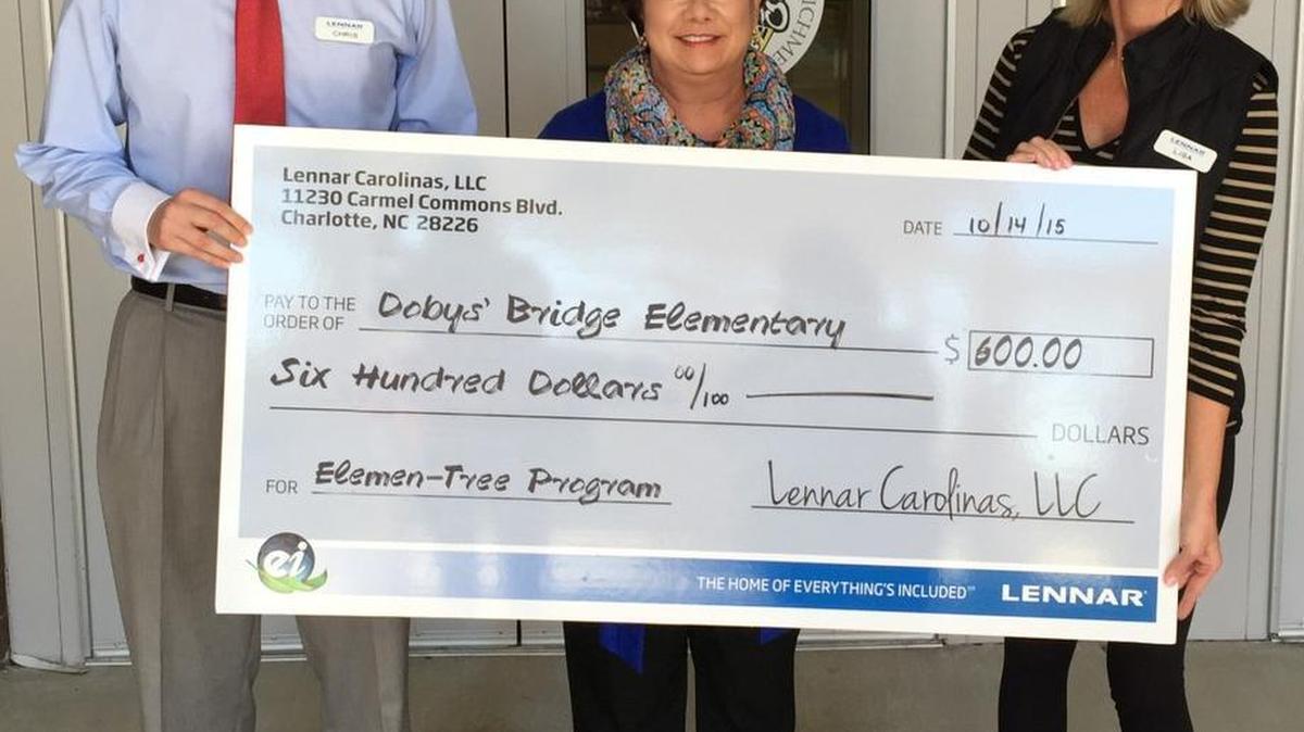 Doby's Bridge Elementary School recently received a grant from Lennar Homes to pay for the cost of planting trees on campus. Presenting it to Principal Jeanette Black (middle) are Lennar New Home Consultants Chris Suttles, (left) and Lisa Baker.