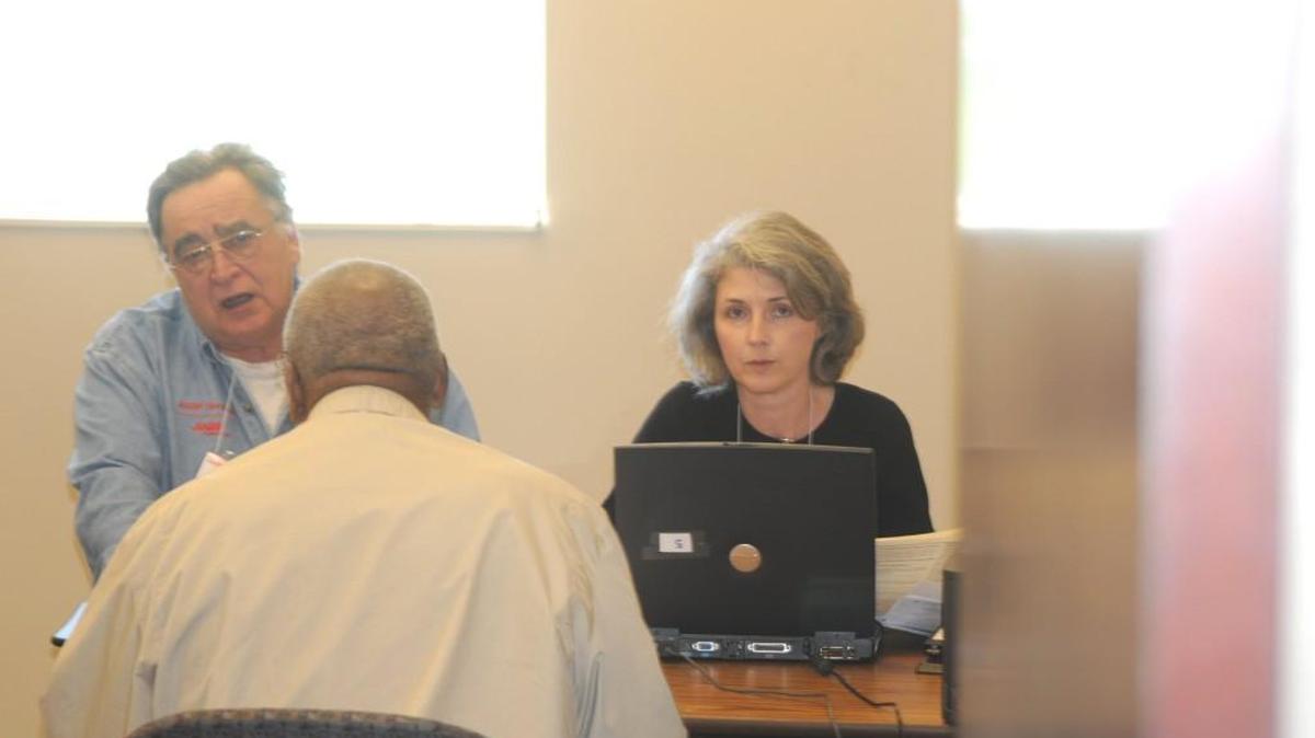 AARP Tax Aide volunteers prepare a tax return for a client at the Fort Mill Library.