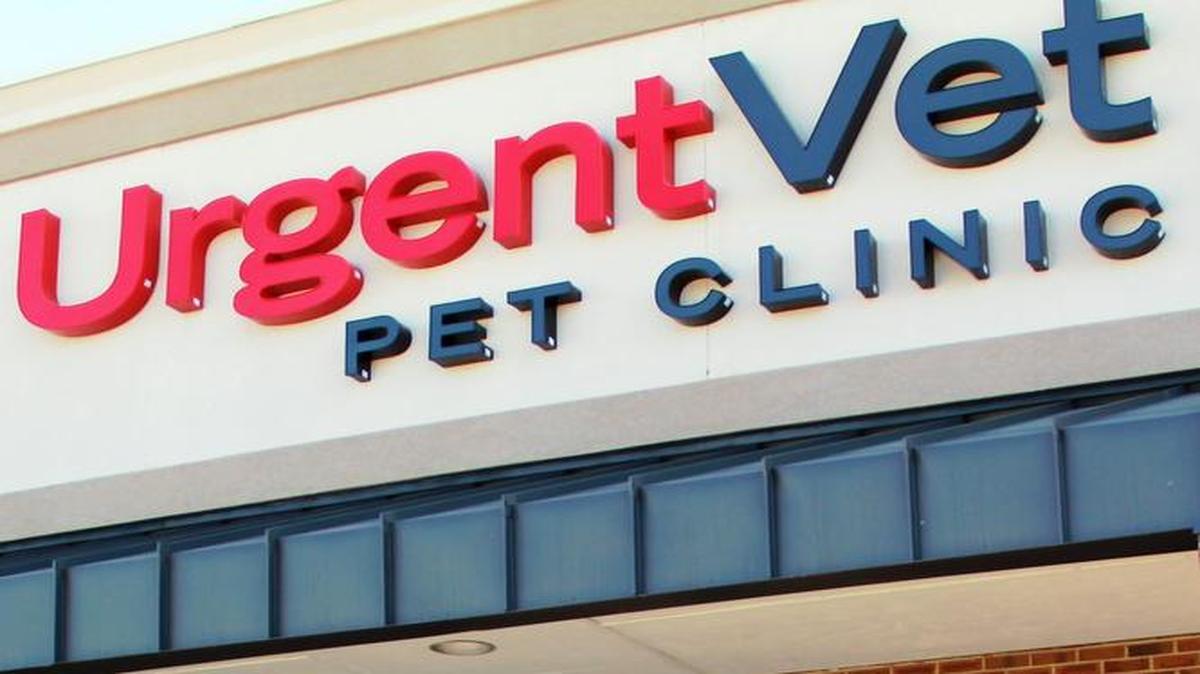 Dr. Jim Dobies cuts the ribbon with staff and Montcross Area Chamber representatives for the opening of his new UrgentVet Pet Clinic in Belmont.