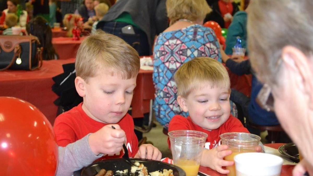 Brothers Paul, left, and David Jeffries enjoy their pancake breakfast Dec. 12 during the River Hills/Lake Wylie Lions Club’s annual event at Camp Thunderbird.
