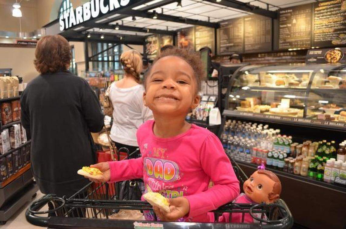 A child smiles after getting a free sugar cookie in this file photo of the grand opening of the Harris Teeter grocery in Fort Mill.