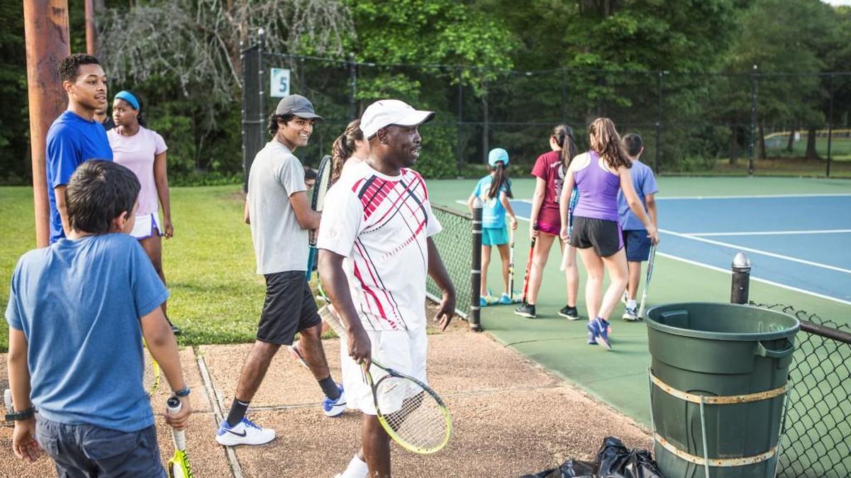 Complex Tennis Director Billy McKinney works with students at the Anne Springs Close Recreation Complex.