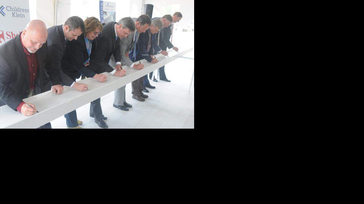 
The Lash Group held a beam signing event Monday, where project and town leaders, including Fort Mill Mayor Danny Funderburk, left, signed the final beam to go atop the new headquarters in Kingsley North.
