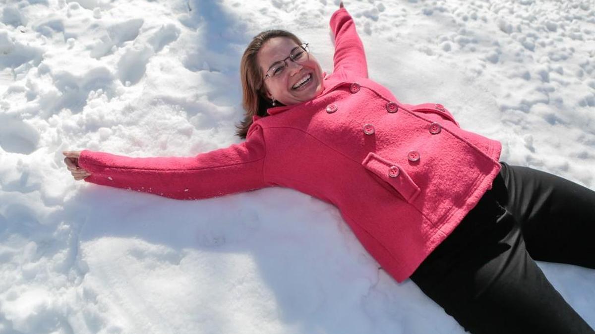 While passing by after lunch, Theresa Houser makes a snow angel in the front yard of the Yanceys Fort Mill home.