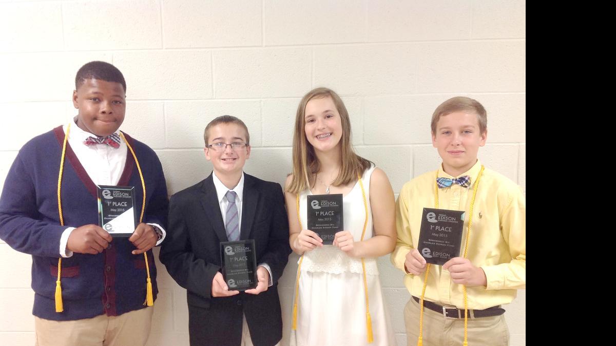 
Banks Trail Middle School eighth-grade students, from left, Arondé Smith, Cody Thomas, Molly Anderson and Andrew Musmacker hold their first-place awards from the 2015 Edison Invention Challenge.
