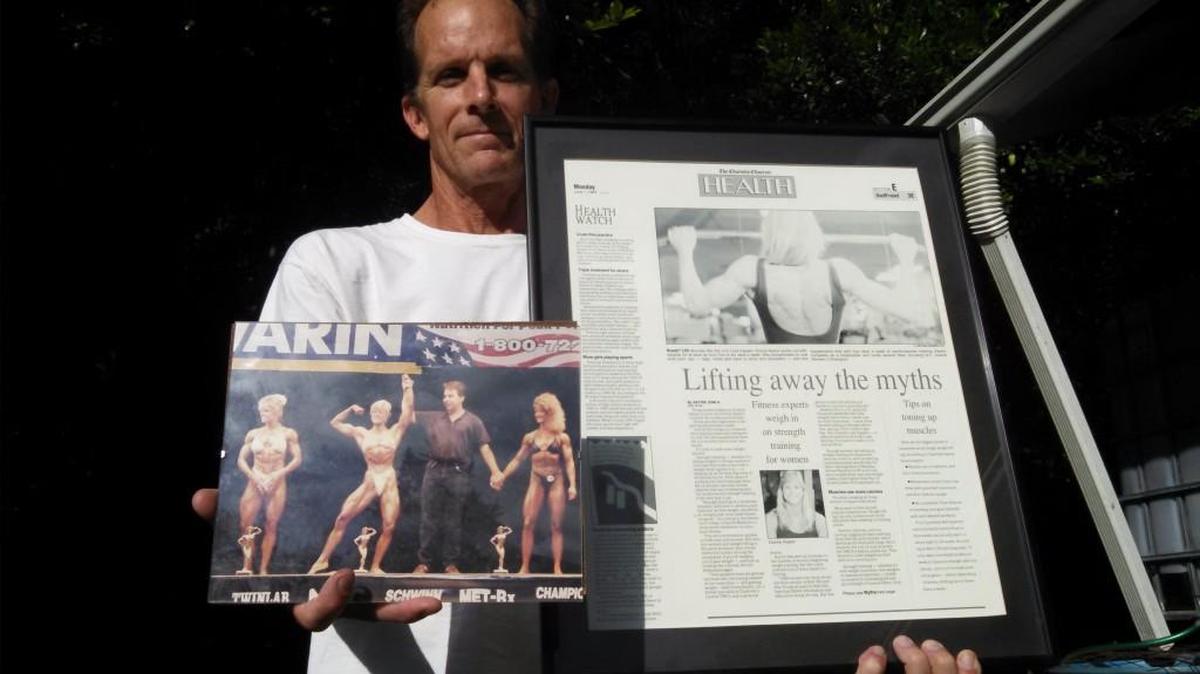 Eric McClellan shows some of the fitness photos of wife Donna, who suffered a severe stroke in July.