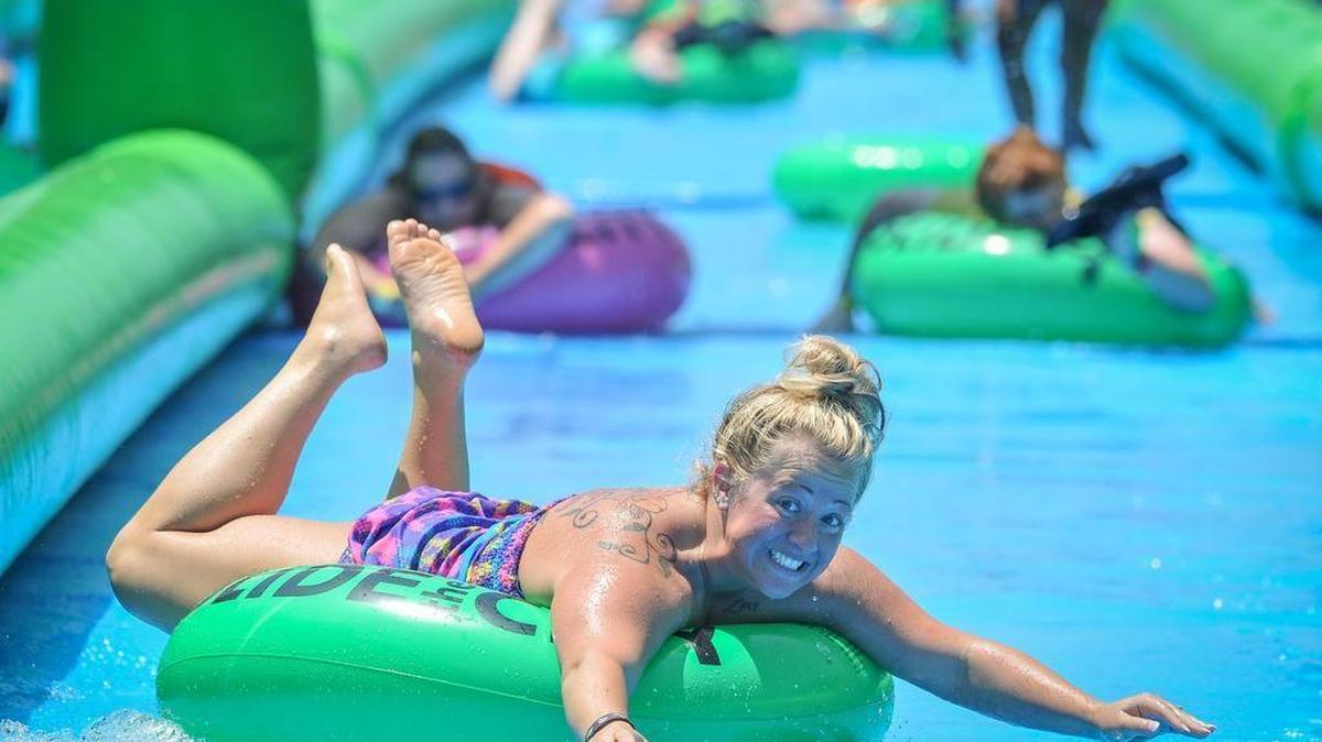 Hands and feet up made for a fast, teeth-gritting ride down the giant Slide The City water slide this past summer in Fort Mill.