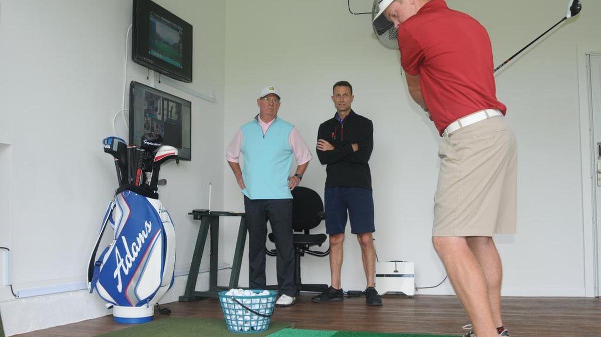 Tommy Jordan and Ken Husvar watch as Ryan Shannon lines up a drive at River Hills Golf Academy in Lake Wylie.