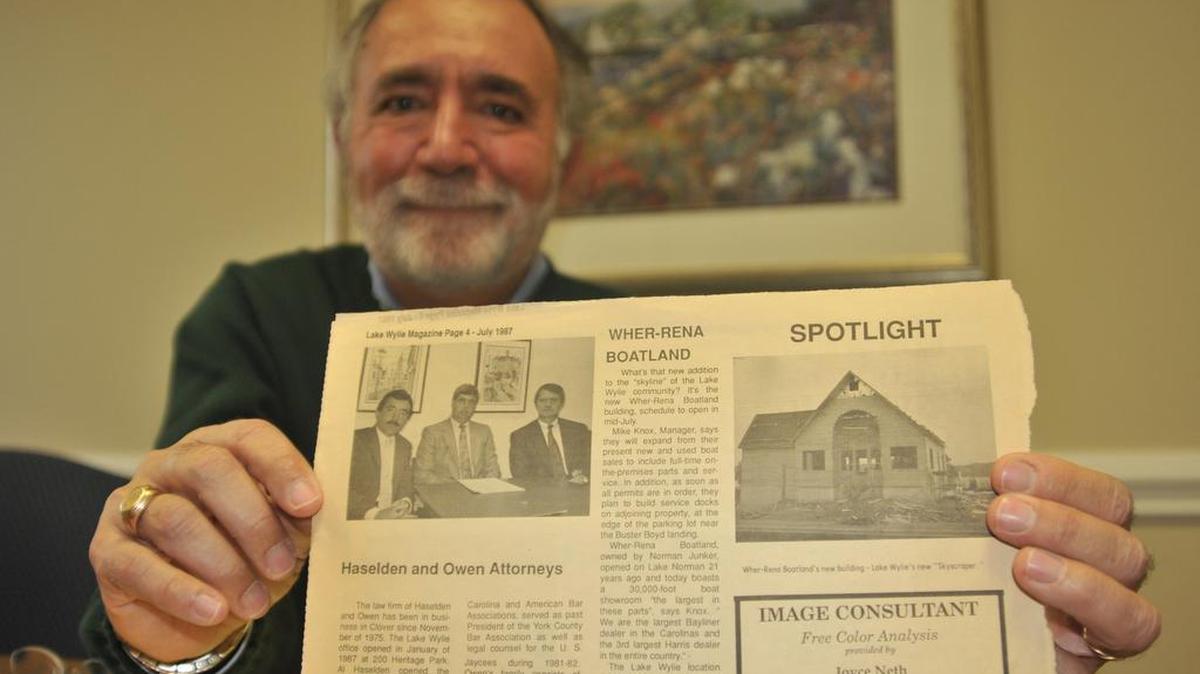 Myron Boloyan looks over a newspaper article from when he opened his law office in 1987 in Lake Wylie. His firm has merged with Halford, Niemiec & Freeman in Fort Mill.