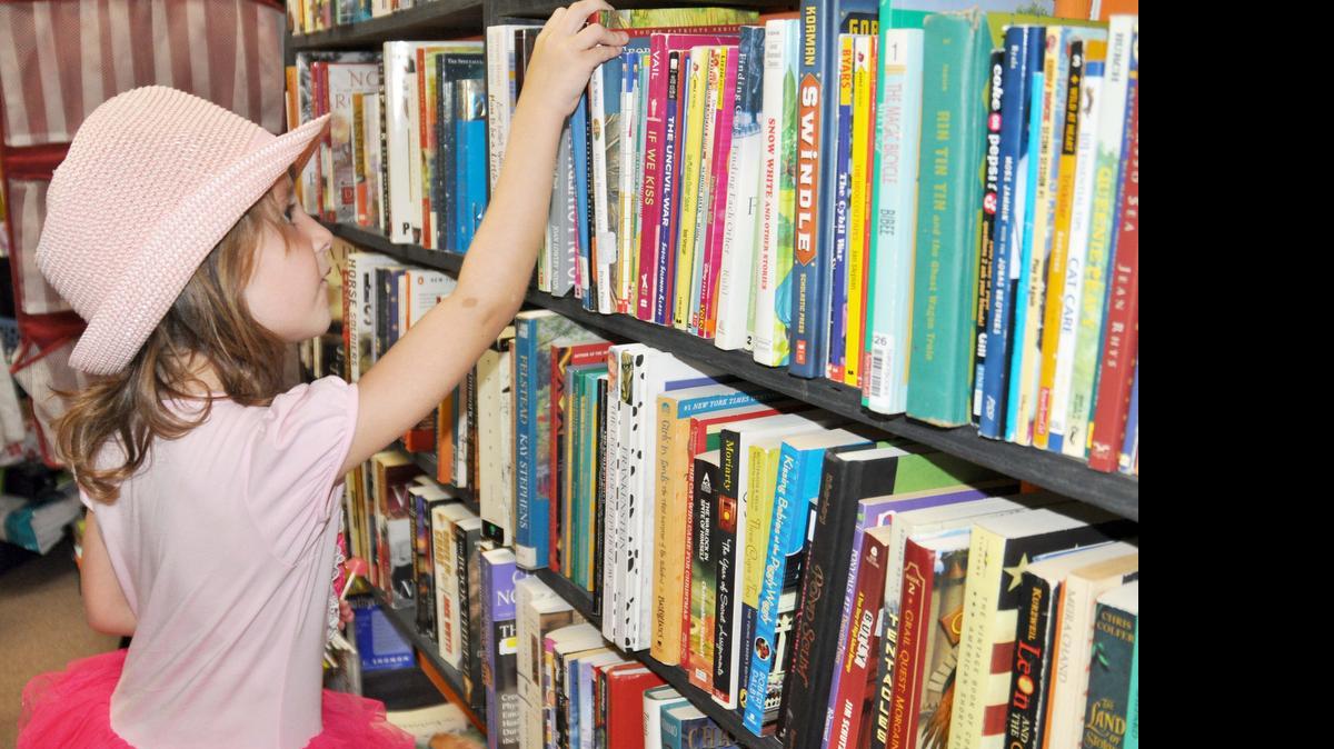 
Gianna Purvis, 5, looks at books May 28 at Sweet Repeat Charitable Thrift Store in Lake Wylie while her mom, Lisa, shops.

