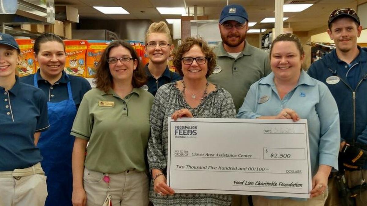 Clover Food Lion store Assistant Manager Katie White, right, presents at check for $2,500 to Karen van Vierssen, executive director for Clover Area Assistance Center.