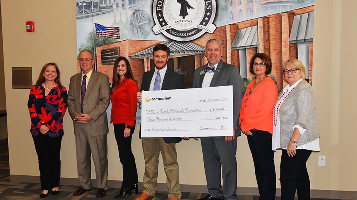Representatives from Comporium Communications present a check to the Foundation for Fort Mill Schools and representatives of the Fort Mill School District. Pictured are: Lynn Ringley, community volunteer with the Foundation for Fort Mill Schools, Fort Mill School District Superintendent Chuck Epps, Pamela Trimnal and Shaun Barnes with Comporium Communications, Foundation for Fort Mill Schools' Executive Director Scott Patterson, Assistant Superintendent Marty McGinn, and Foundation Board Chairwoman Martha Kinard.