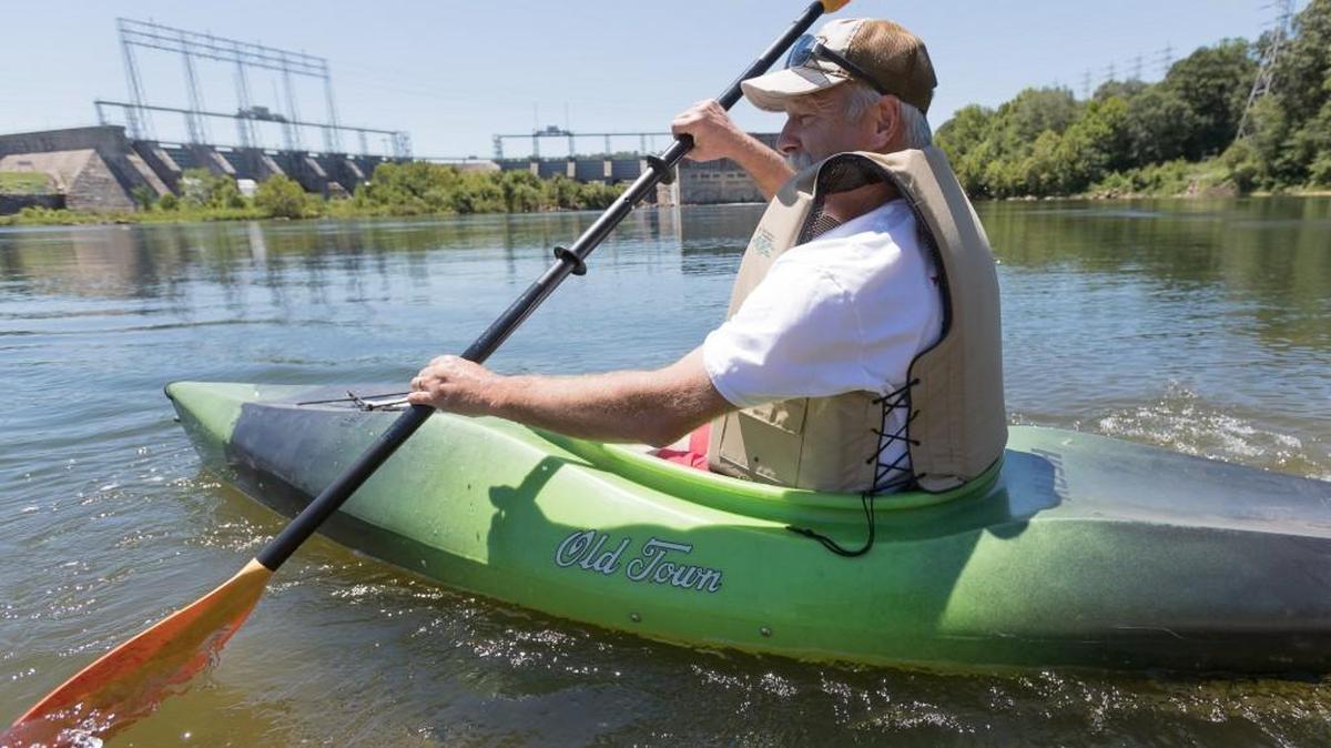 Jon Smith paddles his kayak from the landing below the dam in Fort Mill on his way down to the River Walk landing in Rock Hill. Duke is planning to raise the target water level in lakes Wylie, Norman and James six inches each summer, affecting recreational water flows from Lake Wylie for Catawba River paddlers downstream.