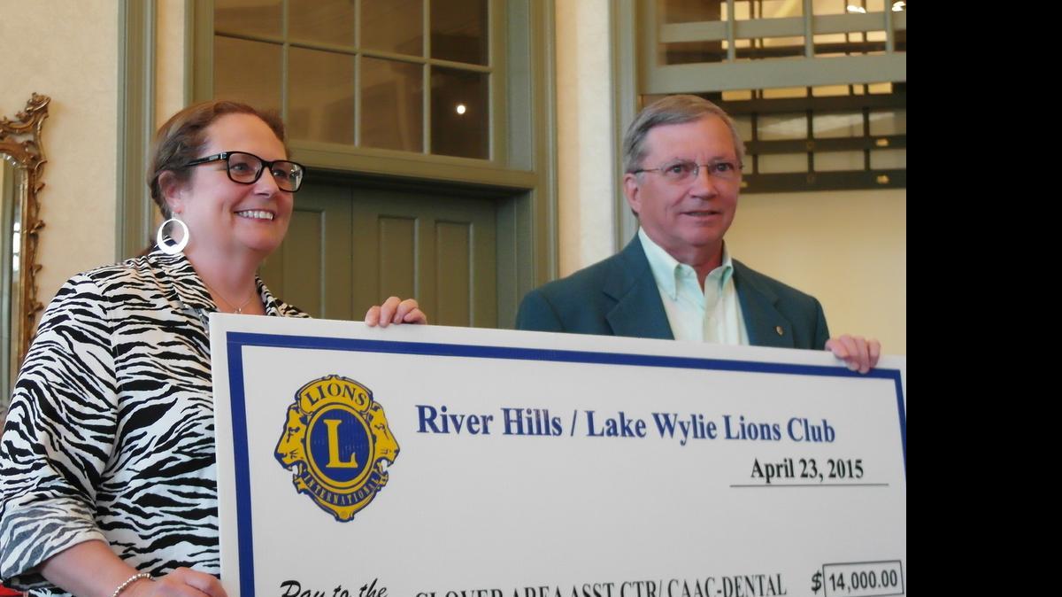 
River Hills/Lake Wylie Lion RJ Phillips, right, presents Clover Area Assistance Center Executive Director Karen van Vierssen with a check for $14,000.
