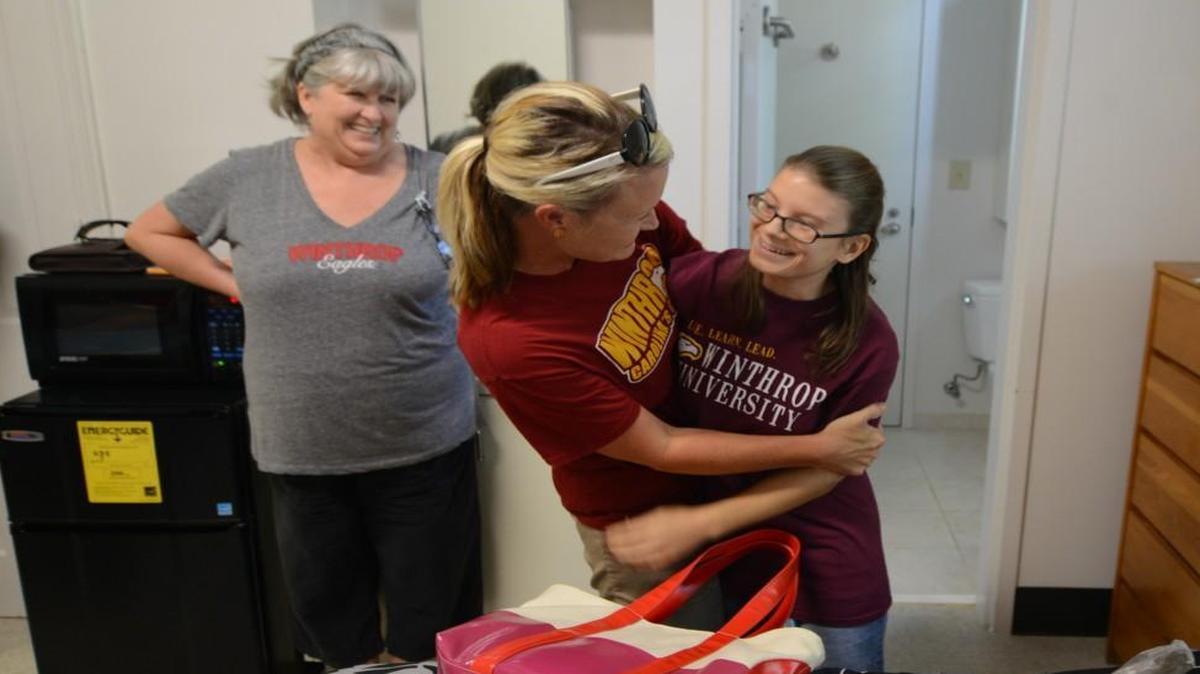 
Basia Oley, right, of Fort Mill gets a welcome-back hug from Jennifer Cease-Cook, director of the Winthrop University Think College, Friday. Behind them is Basia’s mom, Terri. Basia is starting her second year in the school’s program for developmentally challenged students and is one of the program’s three original students.
