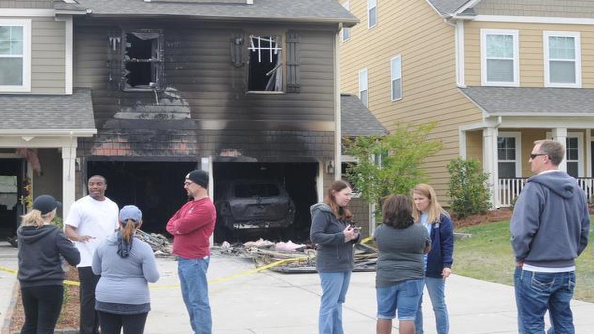 
Neighbors gather on Friday at the Tega Cay home where fire struck Thursday night.
