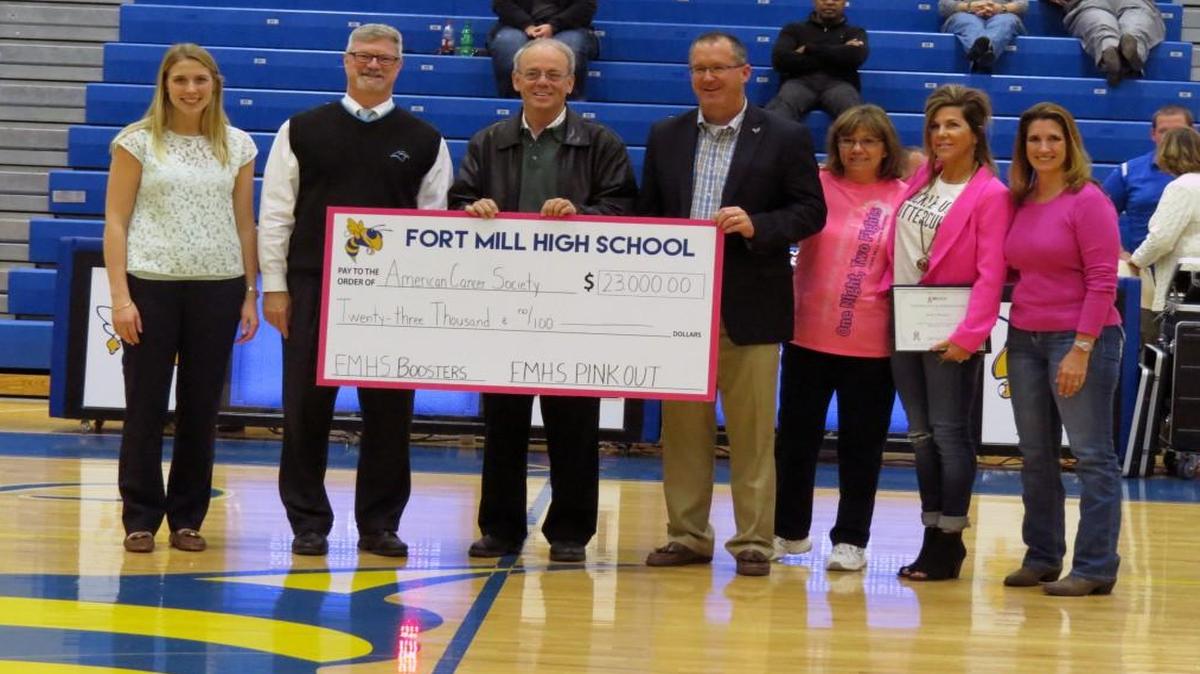 The Fort Mill High School Pink Out committee presented a check for $23,000 for the National Football League and American Cancer Society's A Crucial Catch program during the Dec. 3 basketball game at Fort Mill High School. Shown from left are Meagan Swaim with the American Cancer Society, Riley Fields with the Carolina Panthers, Superintendent Chuck Epps, Fort Mill High School Principal Dee Christopher and Pink Out committee members Judy Lafoe, Lori Hillman and Kay Click.